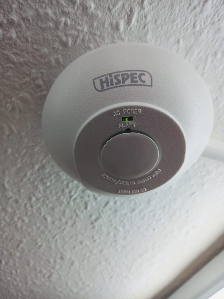 White HiSPEC smoke alarm installed  in a retail setting by local commercial electrician Peter James White Electrical Ltd